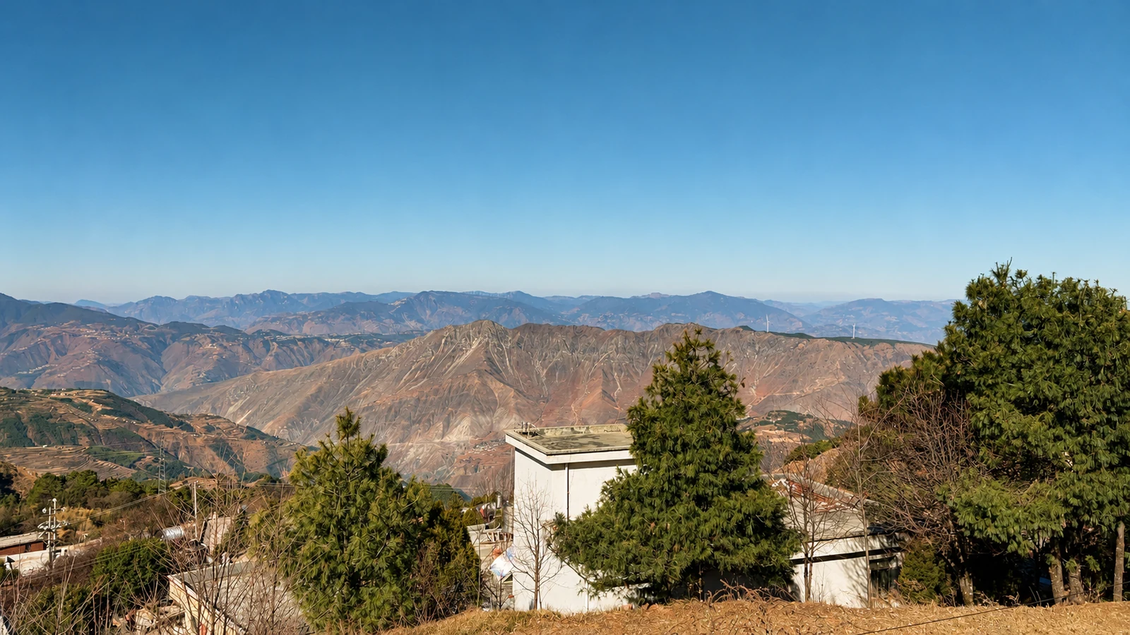 Village surroundings, pine trees and mountain ridges photographed in Yunnan