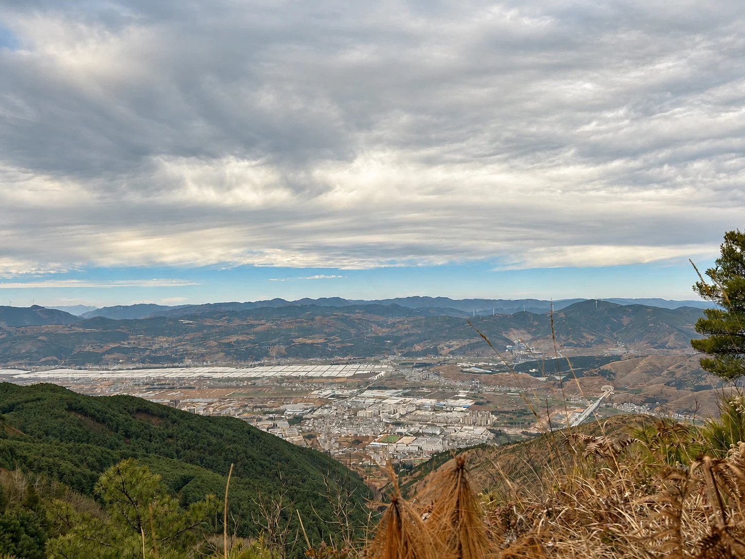 Agricultural valley and settlement viewed from a wooded Yunnan hillside